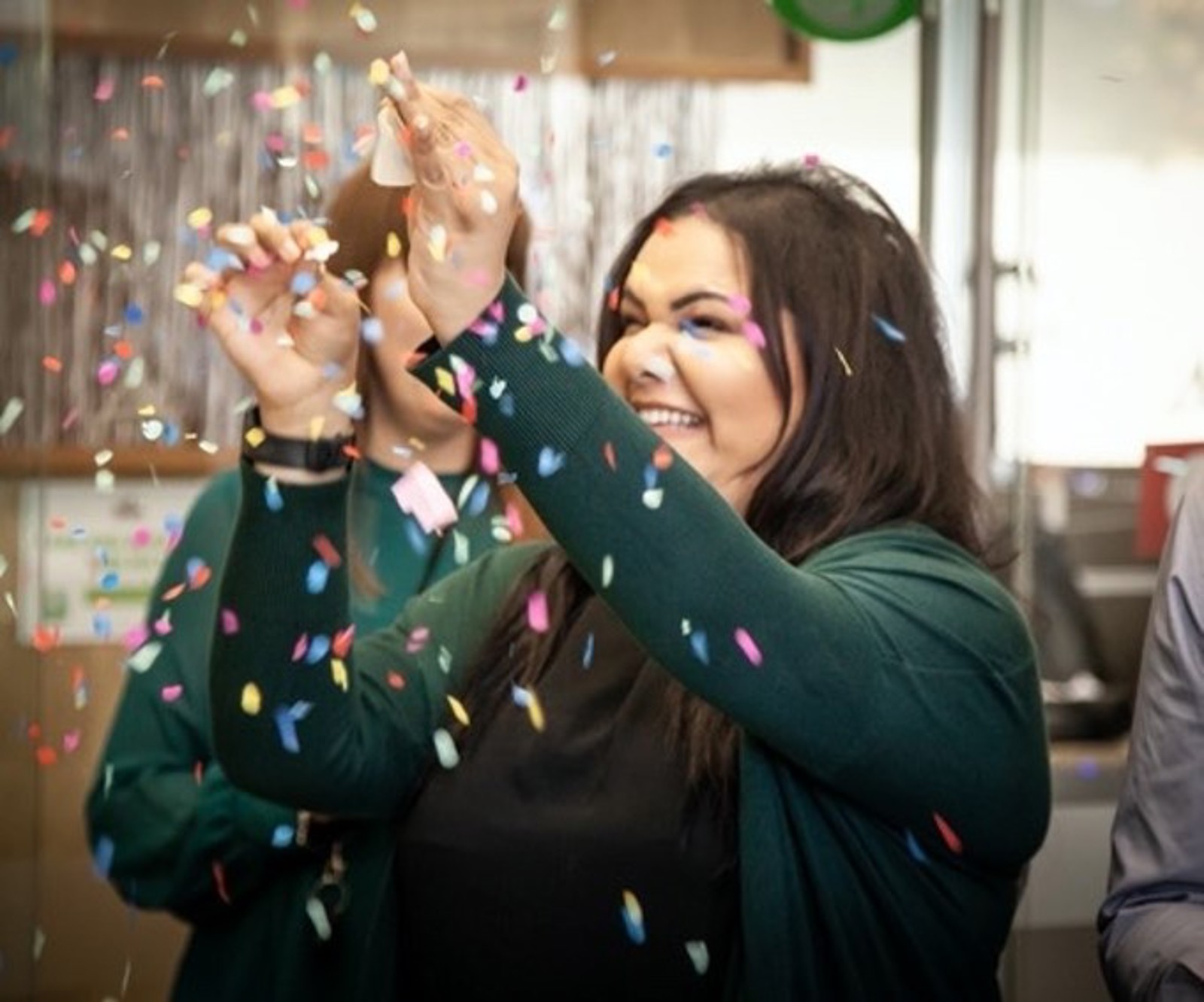Woman with confetti from a party popper
