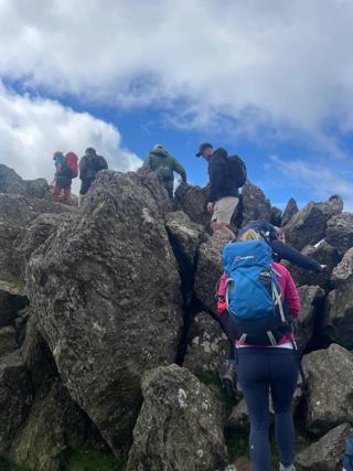 Ardonagh Specialty team walking up big rocks