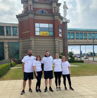 Team pose outside trafford centre abseiling challenge in Manchester
