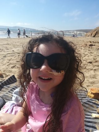 A little girl with Cystic Fibrosis at the beach