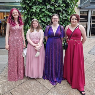 Kaydi stood with three young people, whilst attending the awards ceremony, all in long dresses