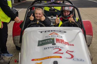 Two girls in a Speed of Sight race car.