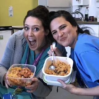 Two female colleagues enjoying food