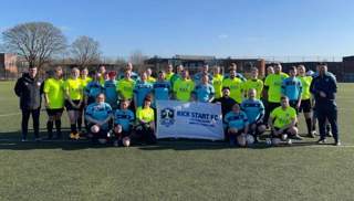 Football focused mental health charity Kick Start FC team pictured with their team flag