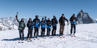 Team of eight who took on the Patrouille des Glaciers fundraising challenge pose on their skis