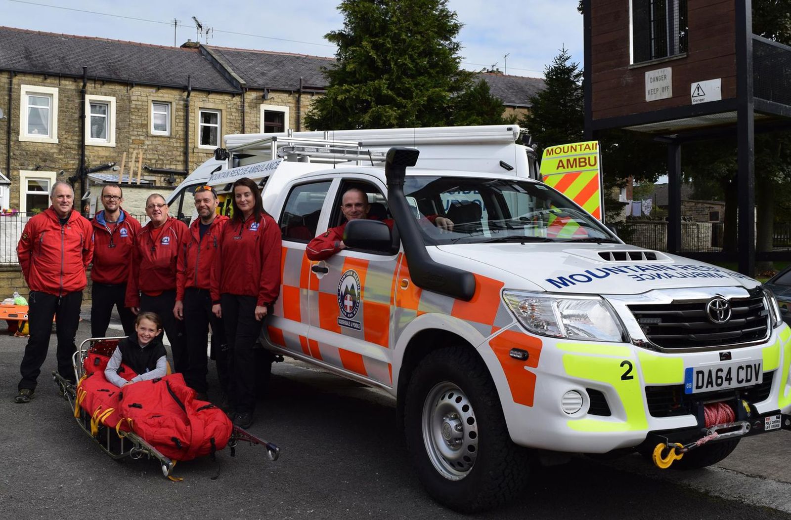 Rossendale And Pendle Mountain Rescue Team standing with emergency vehicle