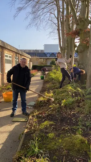 Colleagues volunteer gardening at Maggie's Cancer Centre Manchester
