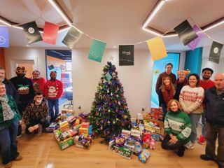 Ardonagh Analytics team gather round Christmas tree for Give Back Week