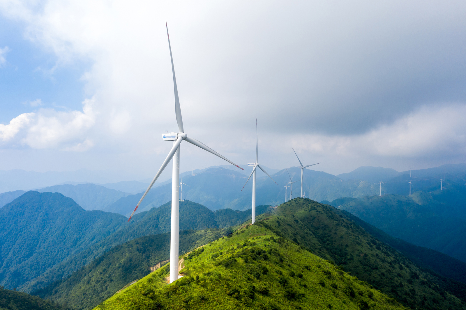 Wind turbine situated on green hills