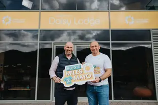 Phil Alexander CEO of Cancer Fund for Children and Rory Best outside Daisy Lodge