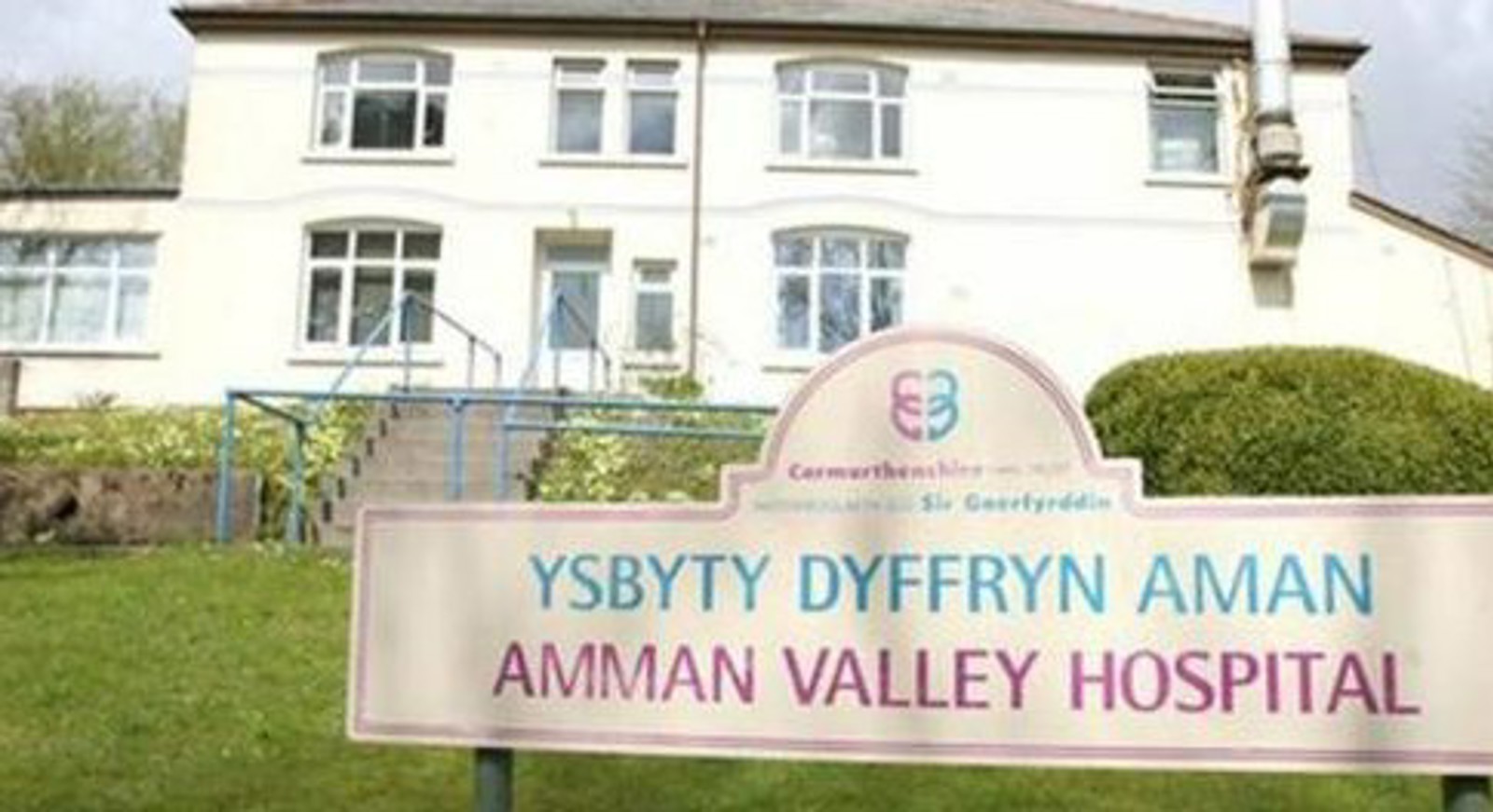 Amman Valley Hospital building and sign outside.