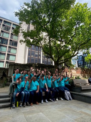 Ardonagh Advisory colleagues sat on a wall as they walk from the office to James' Place London centre