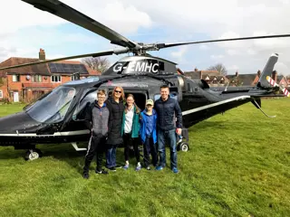Freddie William's (in who's memory the Bright future prize was set up for) family standing outside a helicopter before flight