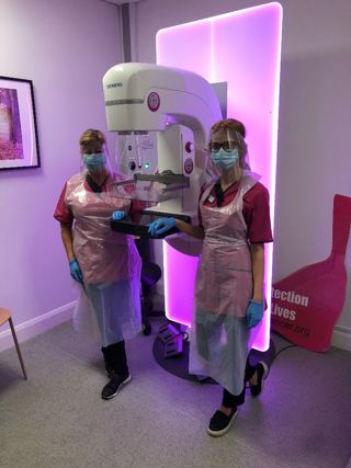 Nurses at Action Cancer with a breast screening machine.