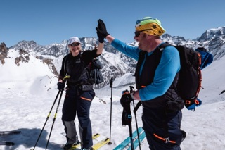 Two members of the Patrouille des Glaciers fundraising challenge team 'high five'
