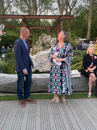 Julie Bentley, CEO, Samaritans, alongside garden designer, Darren Hawkes, who is also a Samaritans Listening Volunteer, stood in front of the garden.