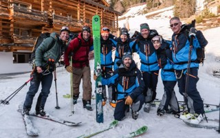 Team of eight pose outside their chalet on the Patrouille des Glaciers fundraising challenge