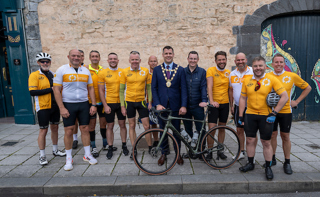 The Ride4Life team stood together at the finish line with their bikes, along with the Mayor and Deputy CEO of Arachas